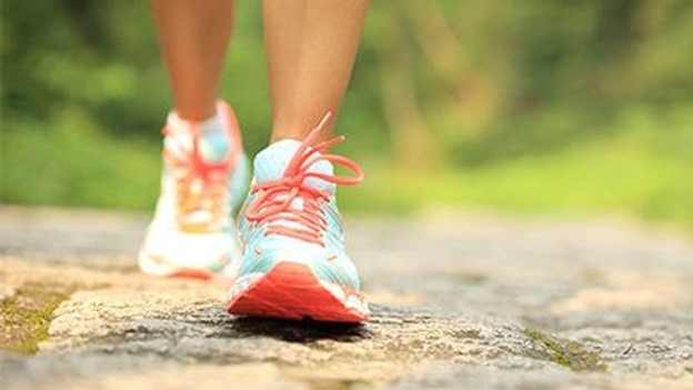 The feet of a person walking.